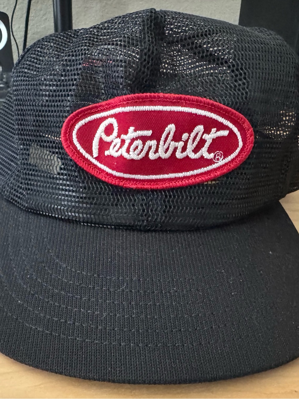 Black Mesh Peterbilt Trucker Hat with Red Logo Patch